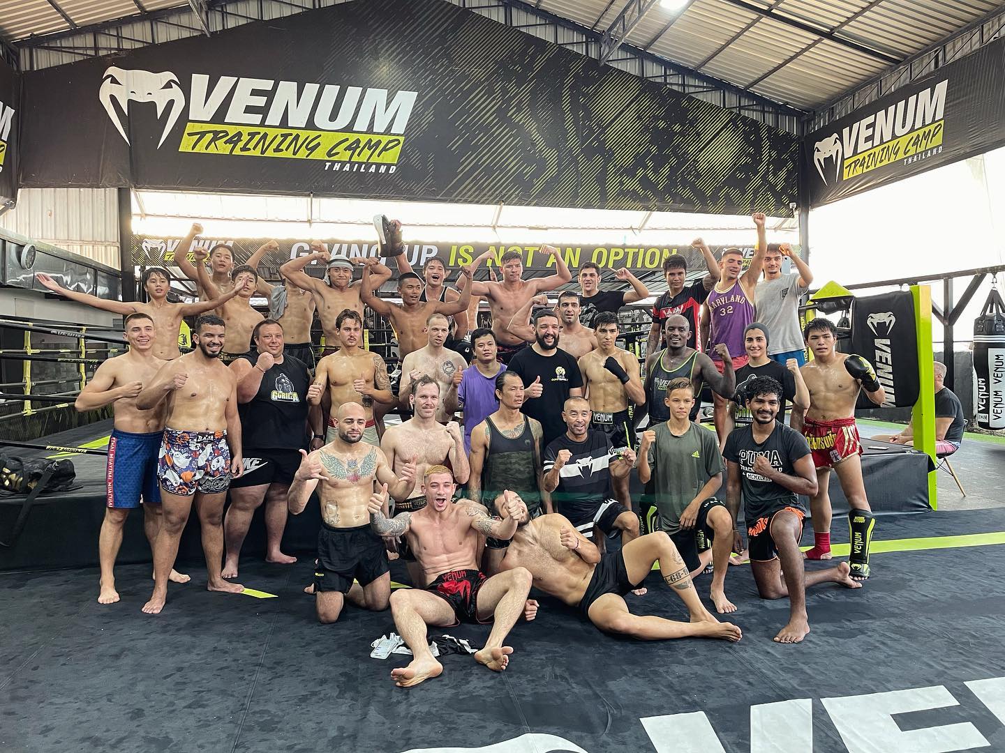 Muay Thai fighters and athletes from the Venum Training Camp in Pattaya pose for a group photo.