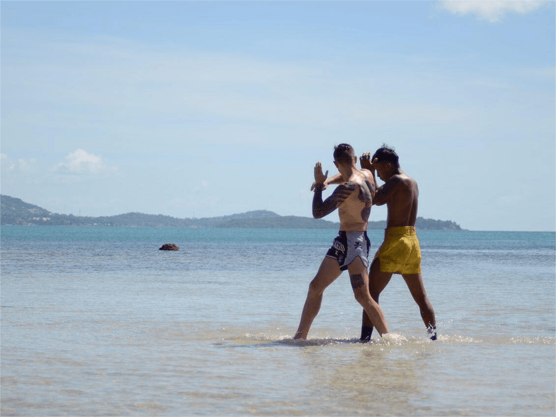 Two fighters from the Tom Muay Thai Gym train on the beach of Koh Samui.