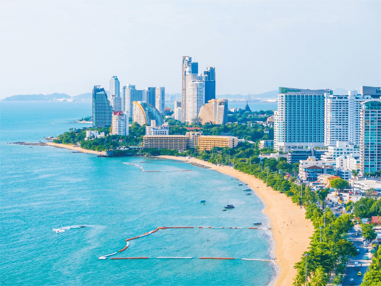 The Pattaya beach promenade with hotels and shopping centers.